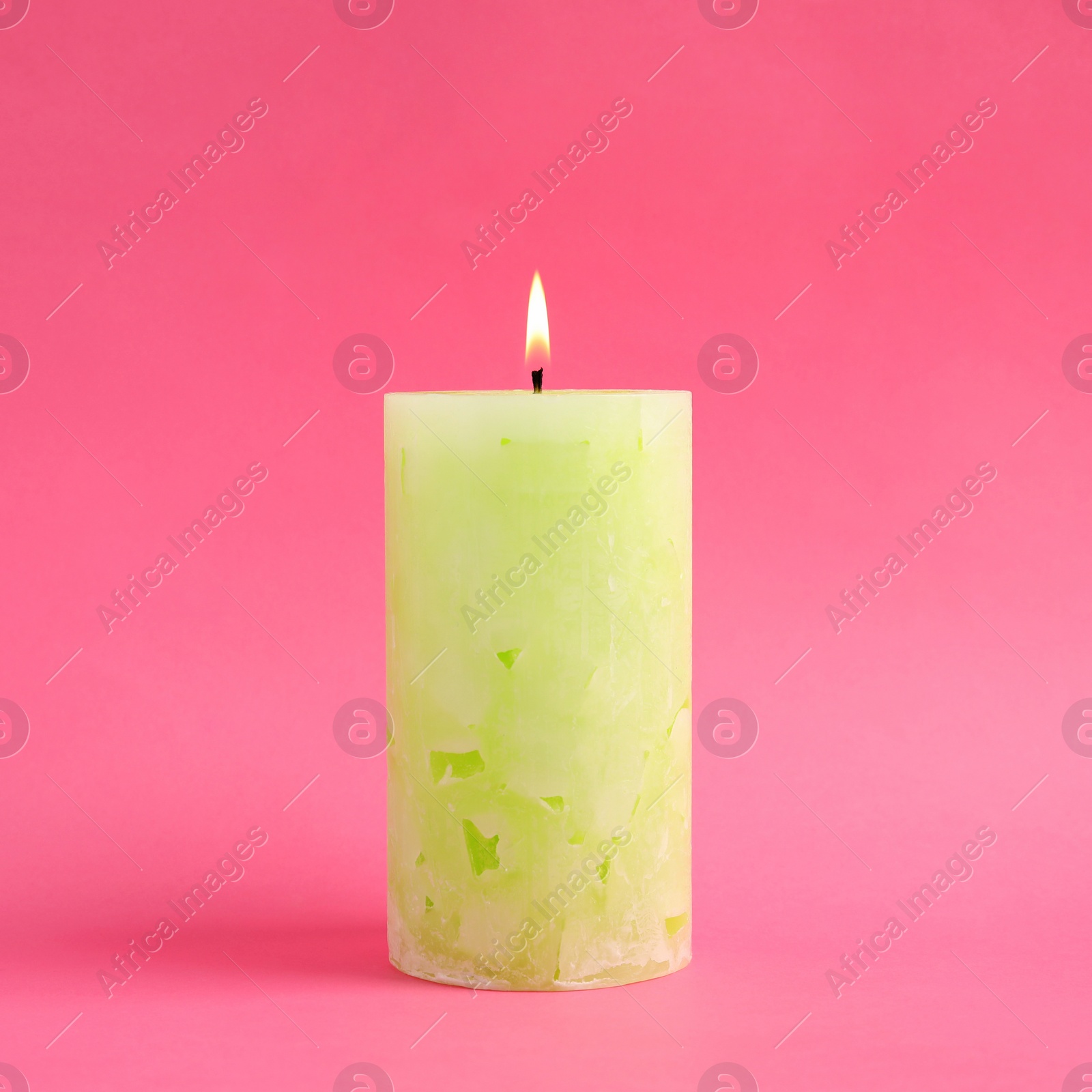 Photo of Alight scented wax candle on color background