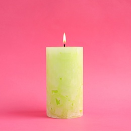 Photo of Alight scented wax candle on color background