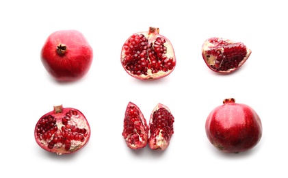 Photo of Ripe pomegranates on white background, flat lay. Delicious fruit