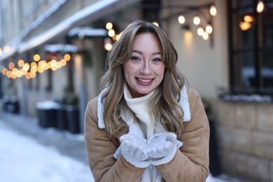 Portrait of smiling woman on city street in winter