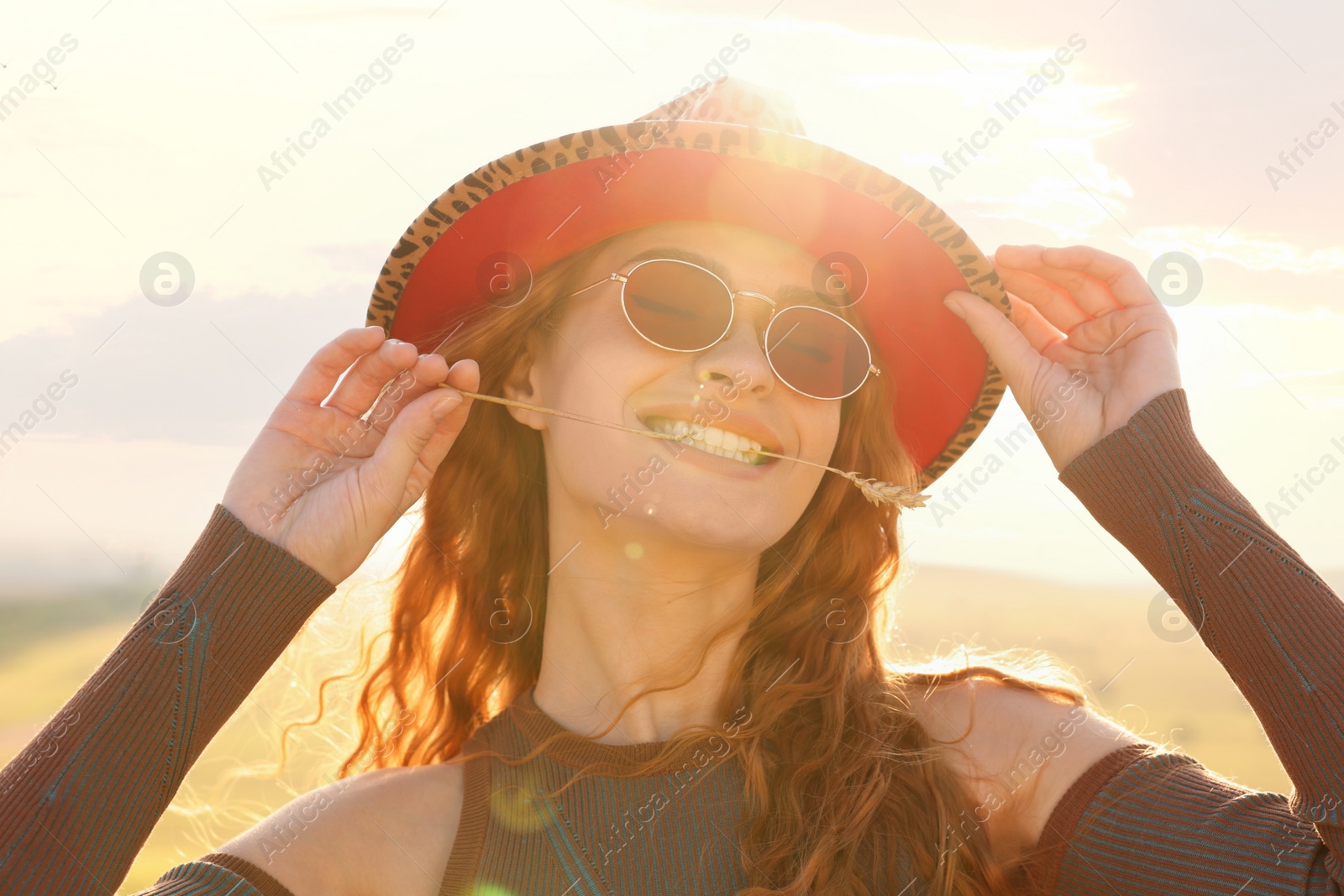 Photo of Beautiful happy hippie woman with spikelet in field