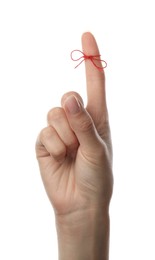 Photo of Woman showing index finger with tied red bow as reminder on white background, closeup