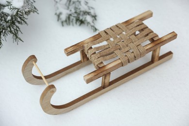 Beautiful decorative wooden sleigh on snow outdoors