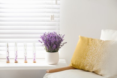 Photo of Beautiful lavender flowers on window sill indoors