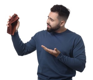 Photo of Upset man showing empty wallet on white background