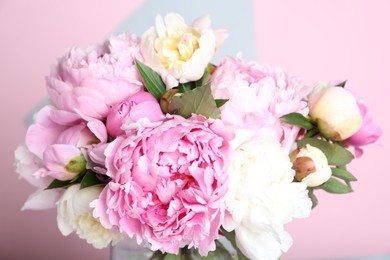 Photo of Bouquet of beautiful peonies on color background, closeup