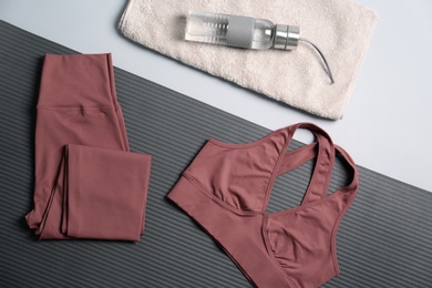 Flat lay composition with yoga equipment on grey background