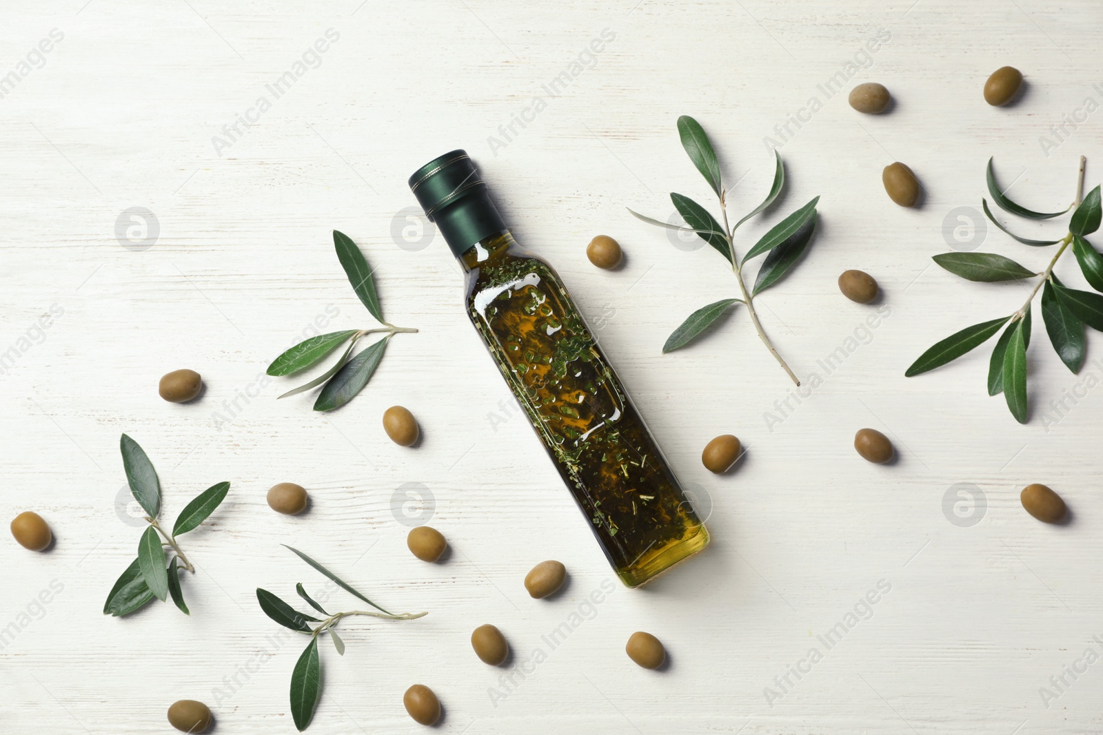 Photo of Flat lay composition with bottle of olive oil on white wooden background