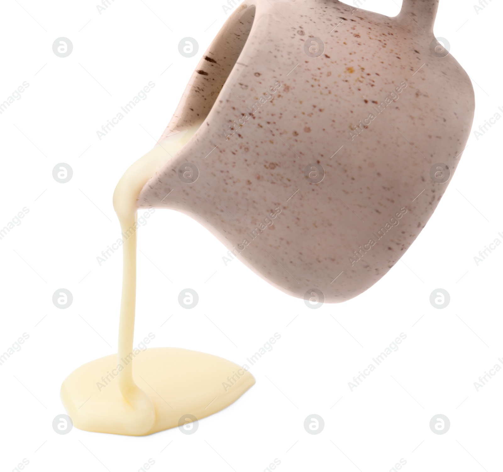 Photo of Pouring condensed milk from jug isolated on white