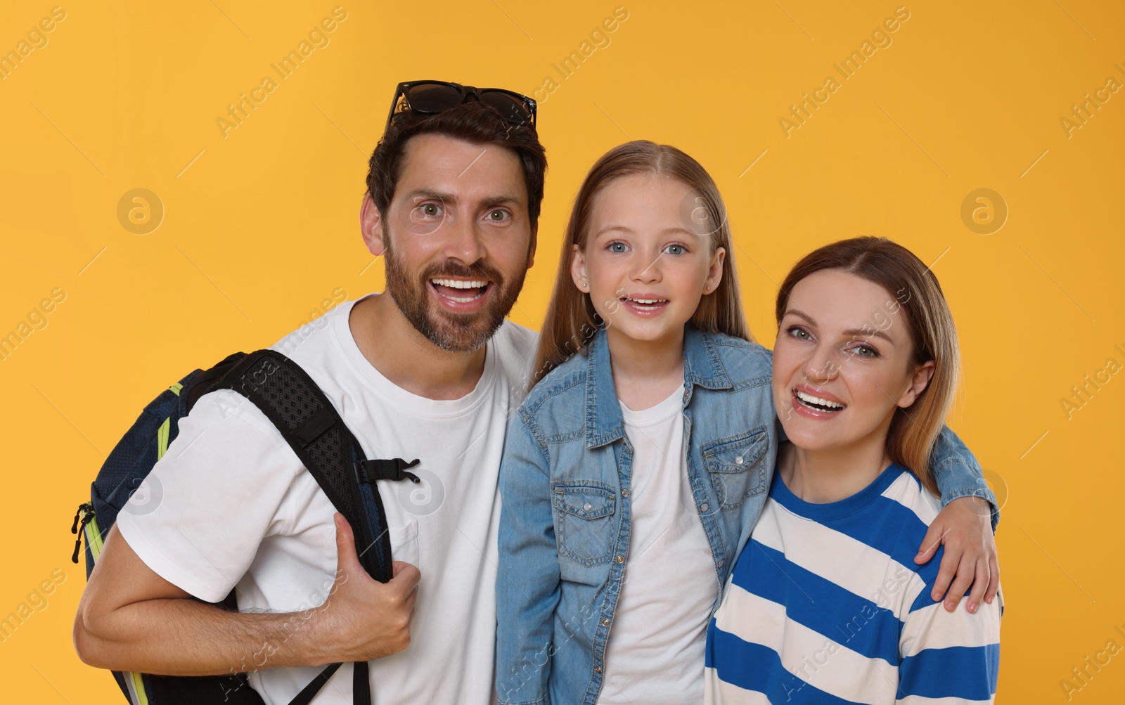 Photo of Portrait of happy family on orange background