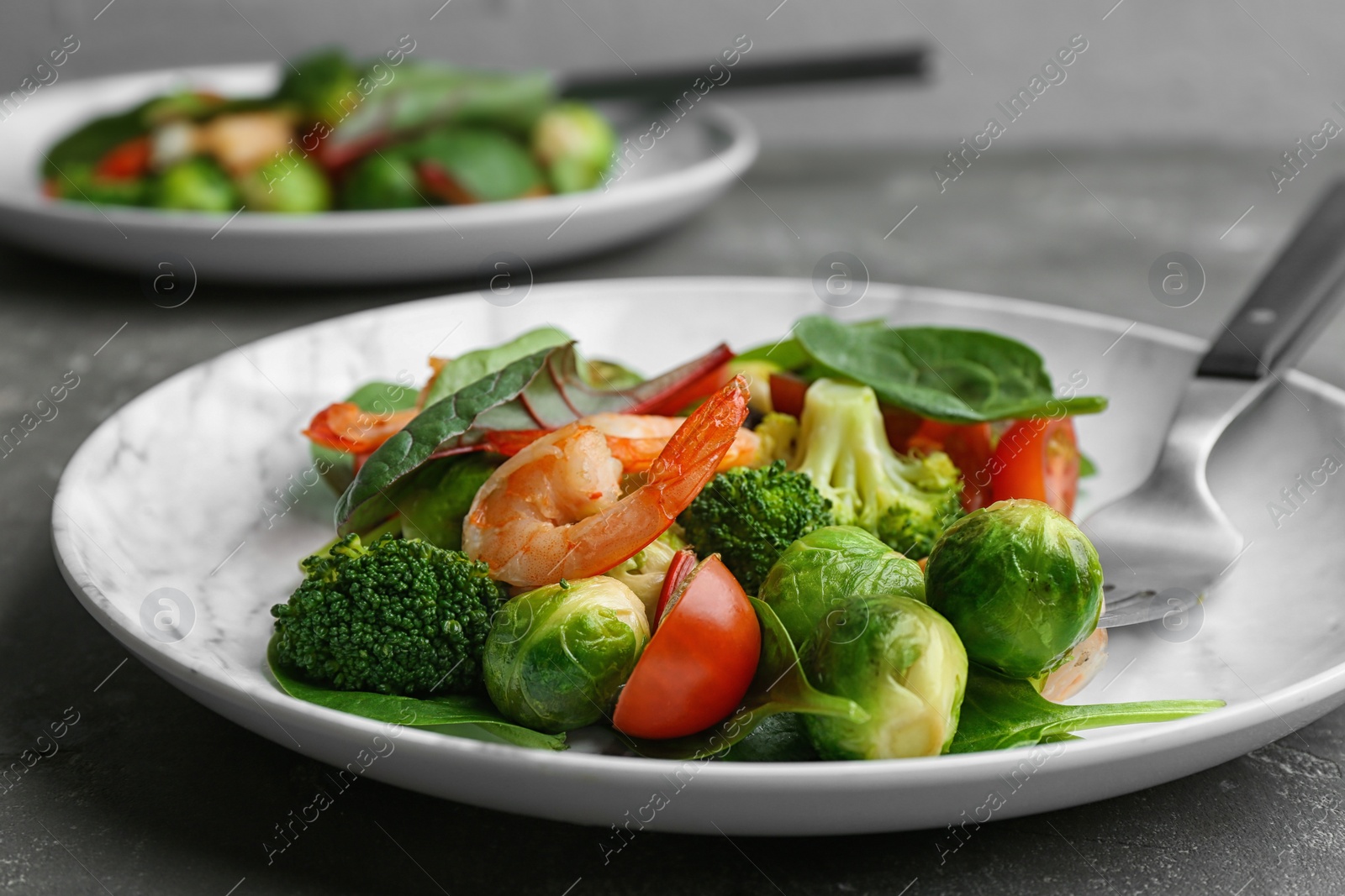 Photo of Tasty salad with Brussels sprouts on grey table, closeup