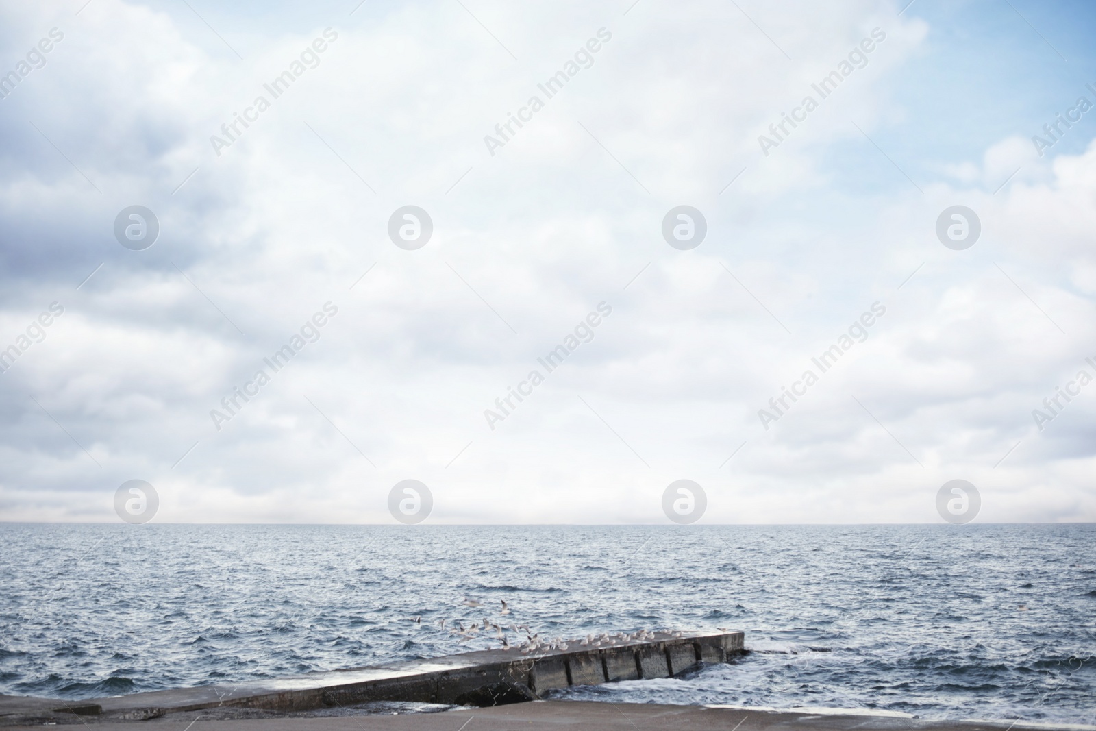 Photo of Beautiful view of pier and sea on cloudy day