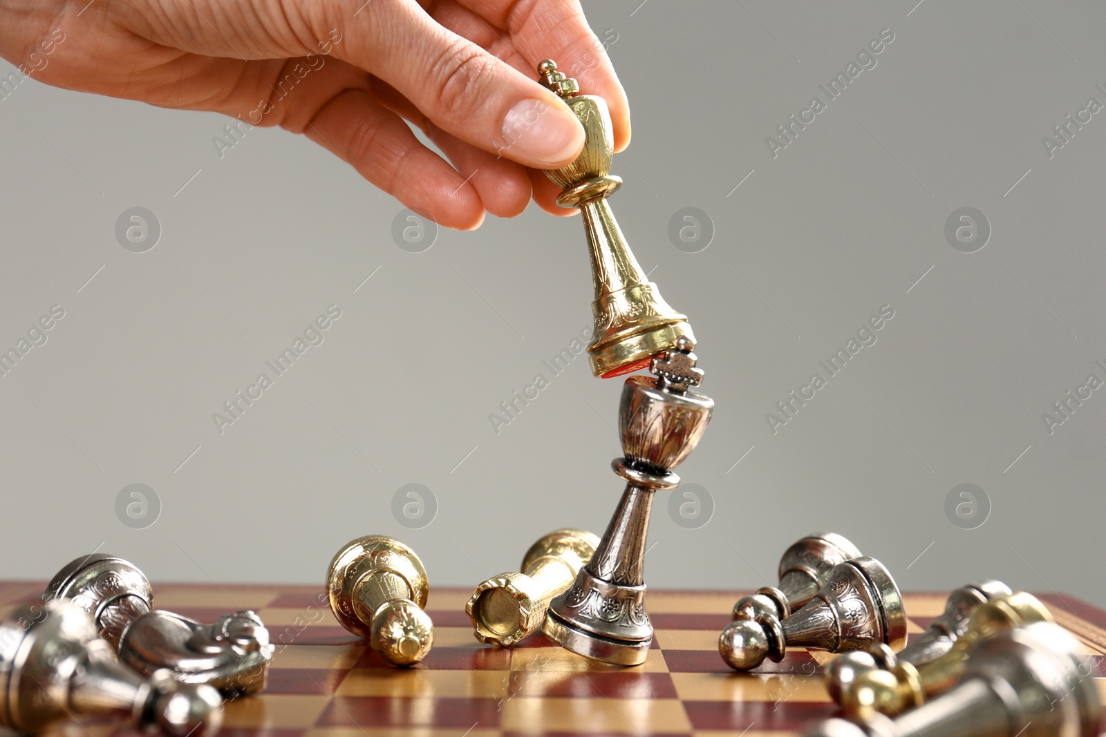 Photo of Woman moving chess piece on board, closeup