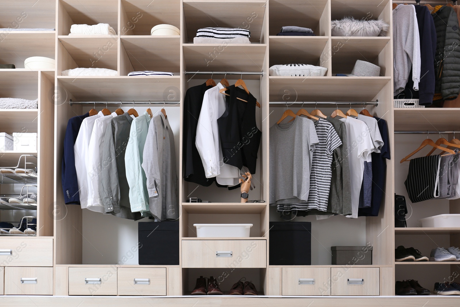 Photo of Stylish clothes, shoes and home stuff in large wardrobe closet