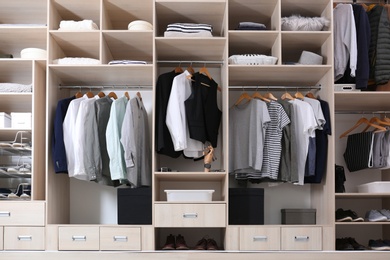 Stylish clothes, shoes and home stuff in large wardrobe closet