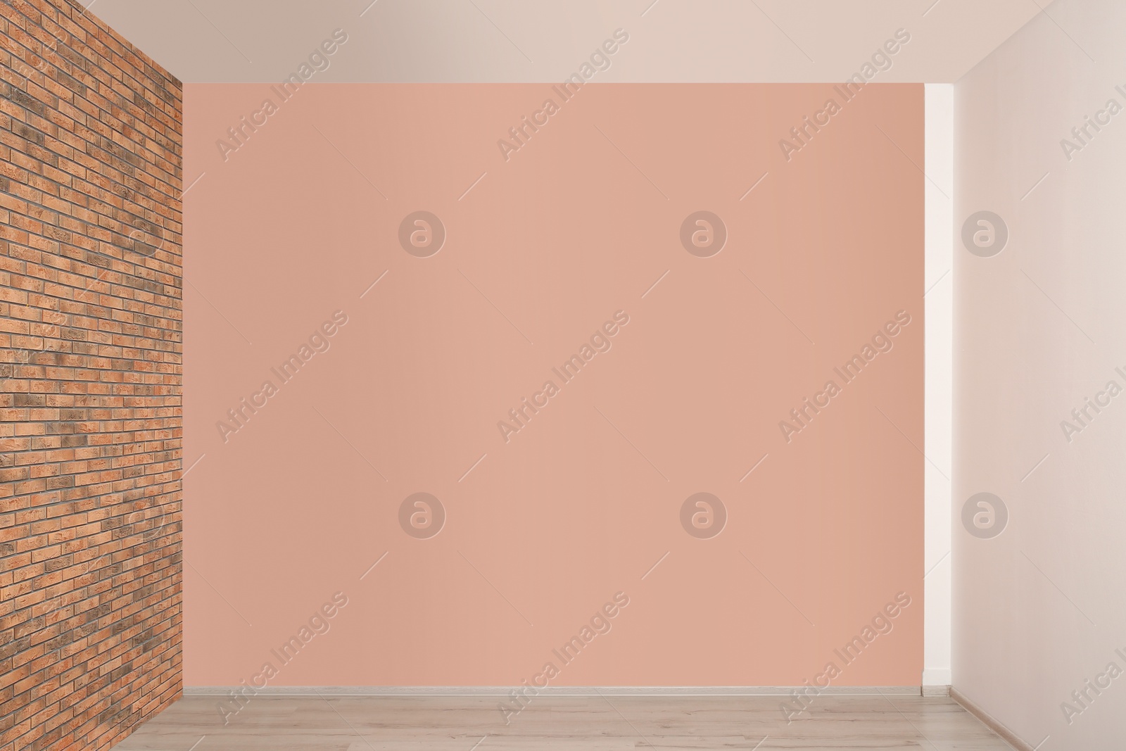 Photo of Empty room with different walls, white door and laminated floor