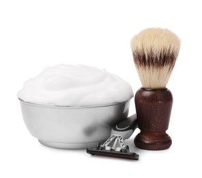 Shaving brush, foam and razor on white background