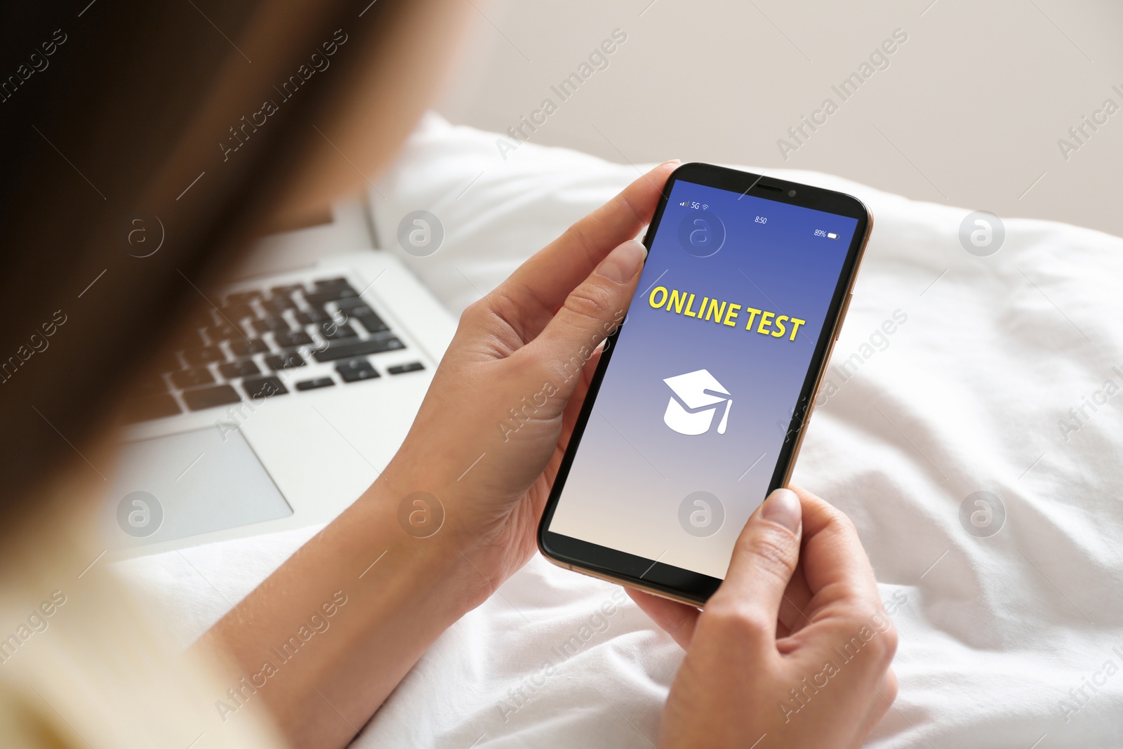 Image of Woman using smartphone for online test indoors, closeup