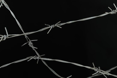 Photo of Shiny metal barbed wire on black background