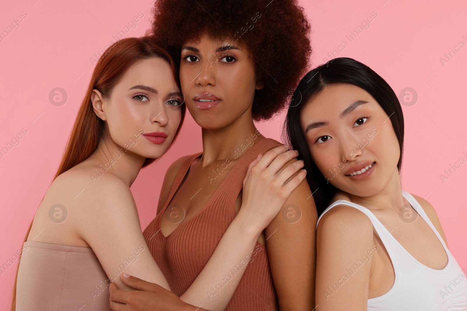 Photo of Portrait of beautiful young women on pink background