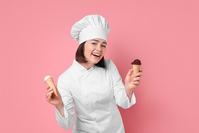 Happy confectioner with delicious ice cream cones on pink background