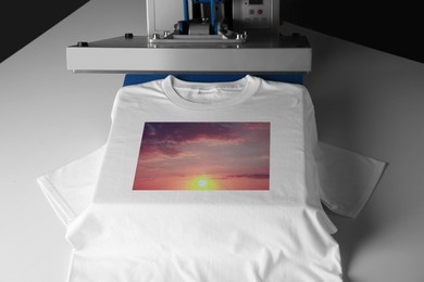 Image of Custom t-shirt. Using heat press to print image of beautiful sunset sky