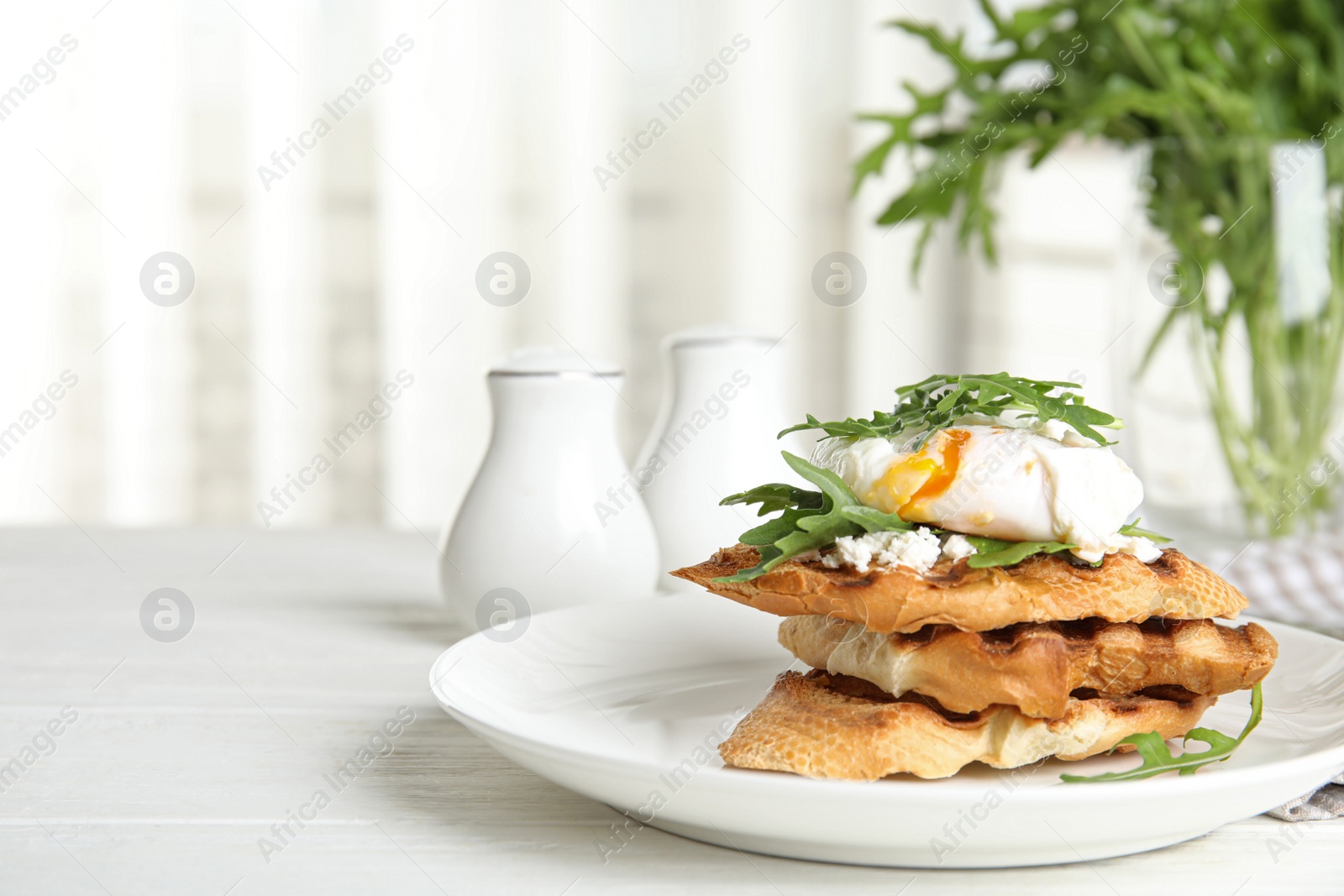 Photo of Delicious sandwich with arugula and egg on white wooden table. Space for text