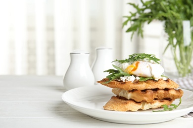 Photo of Delicious sandwich with arugula and egg on white wooden table. Space for text