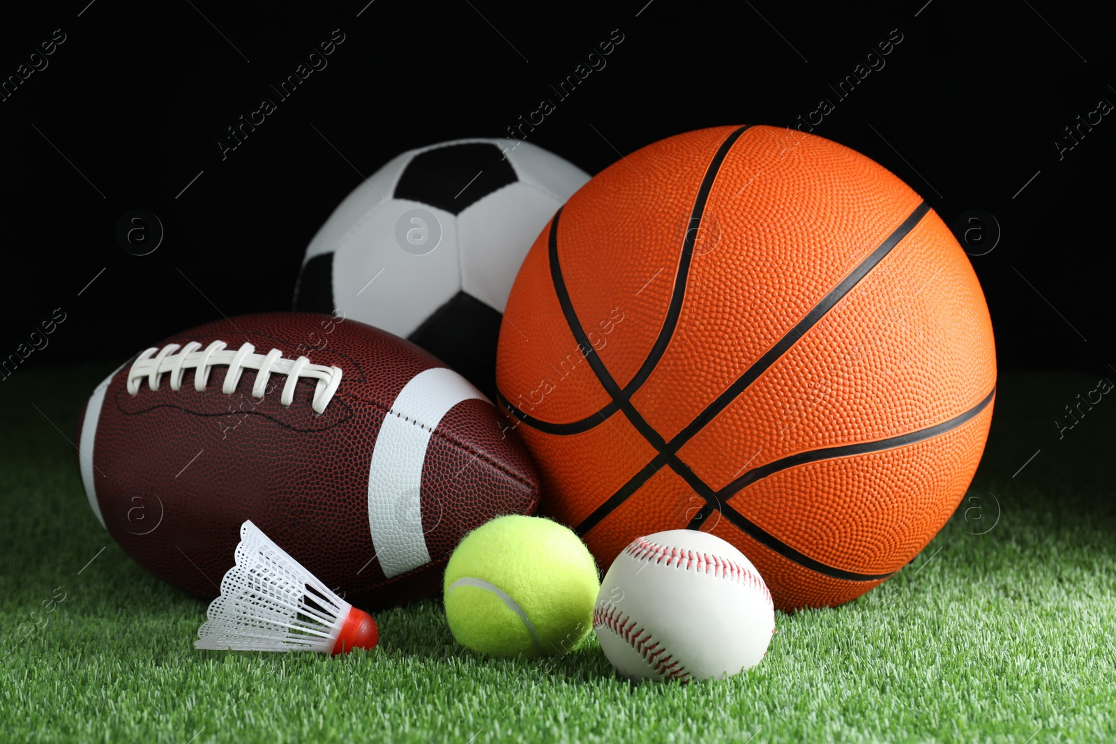 Photo of Set of different sport balls and shuttlecock on green grass