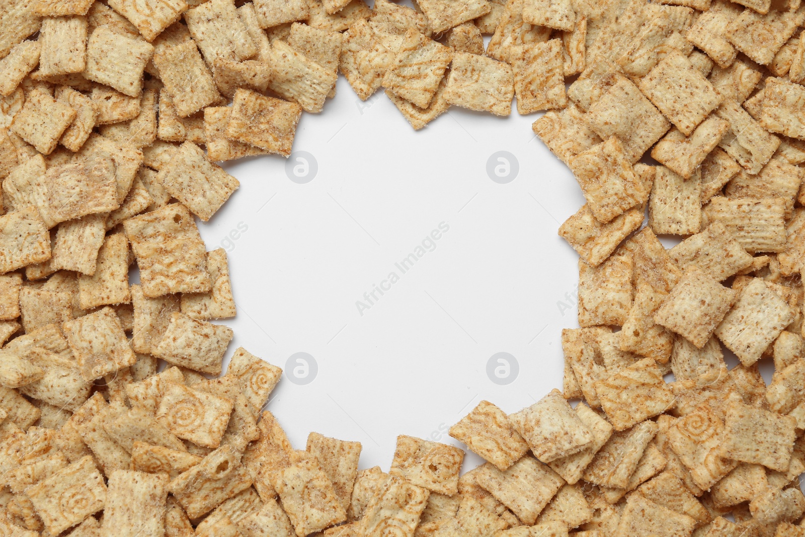 Photo of Frame of crispy crackers on white background, top view. Space for text