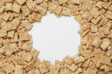 Photo of Frame of crispy crackers on white background, top view. Space for text