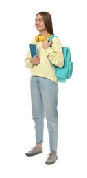 Teenage student with headphones, backpack and book on white background