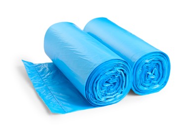 Photo of Rolls of light blue garbage bags on white background. Cleaning supplies