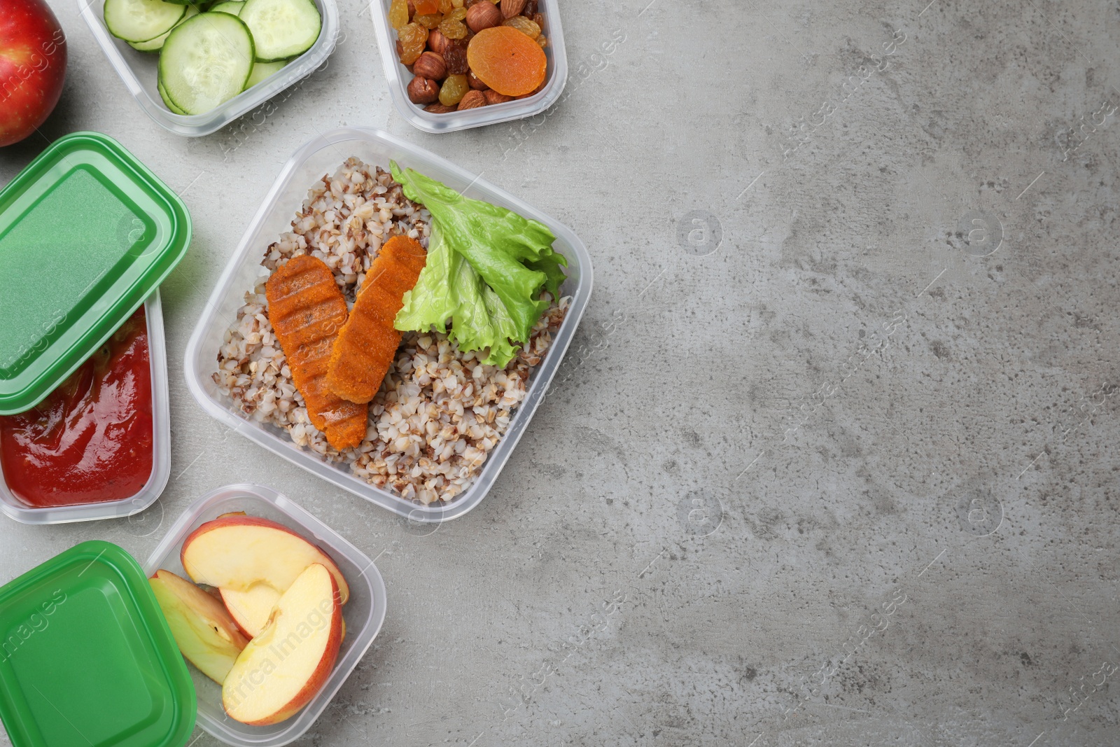 Photo of Set of plastic containers with fresh food on light grey table, flat lay. Space for text