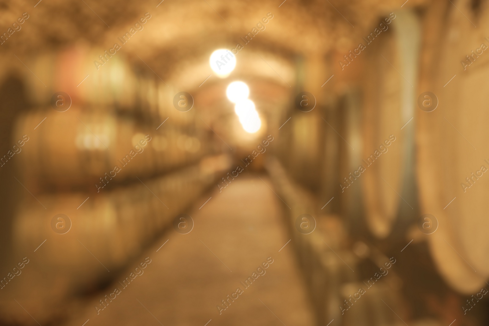 Photo of Blurred view of wine cellar with large wooden barrels