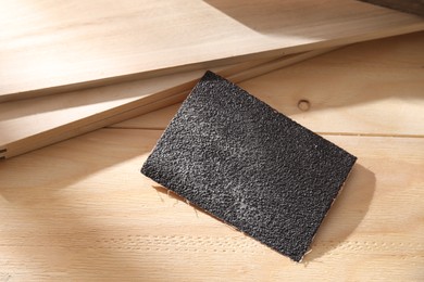 One coarse sandpaper on wooden planks, above view