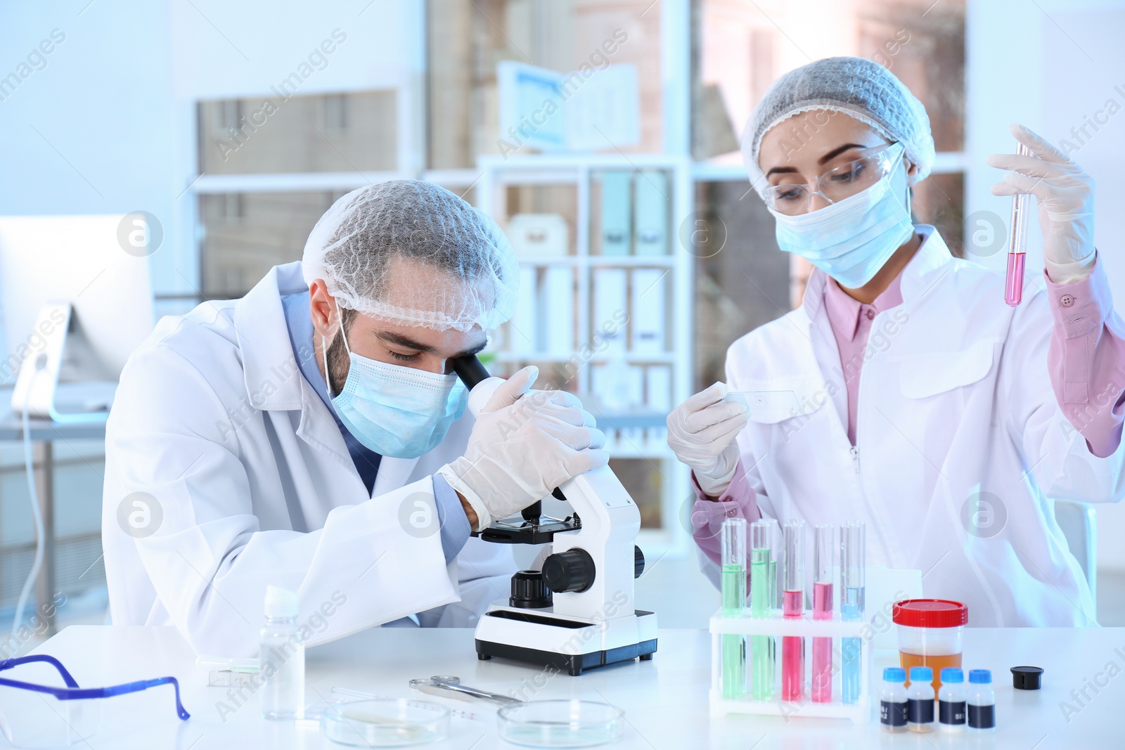 Photo of Young scientists working in laboratory. Chemical analysis