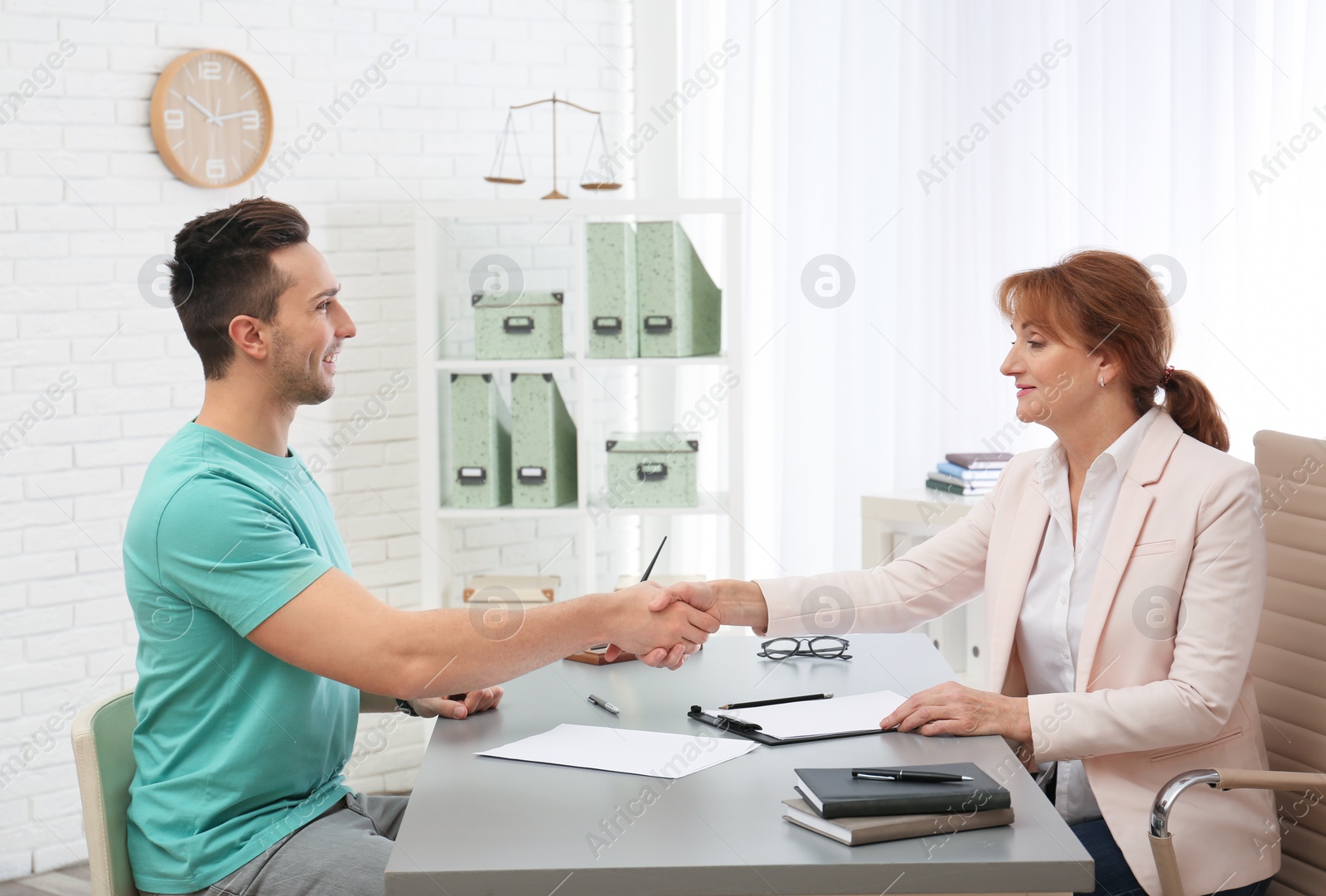 Photo of Young man having meeting with lawyer in office