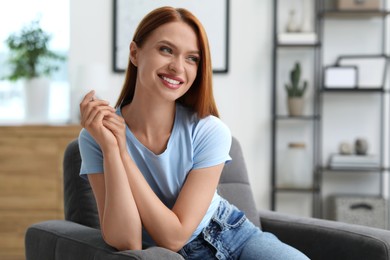 Photo of Portrait of beautiful smiling young woman. Happy lady with red hair at home. Space for text