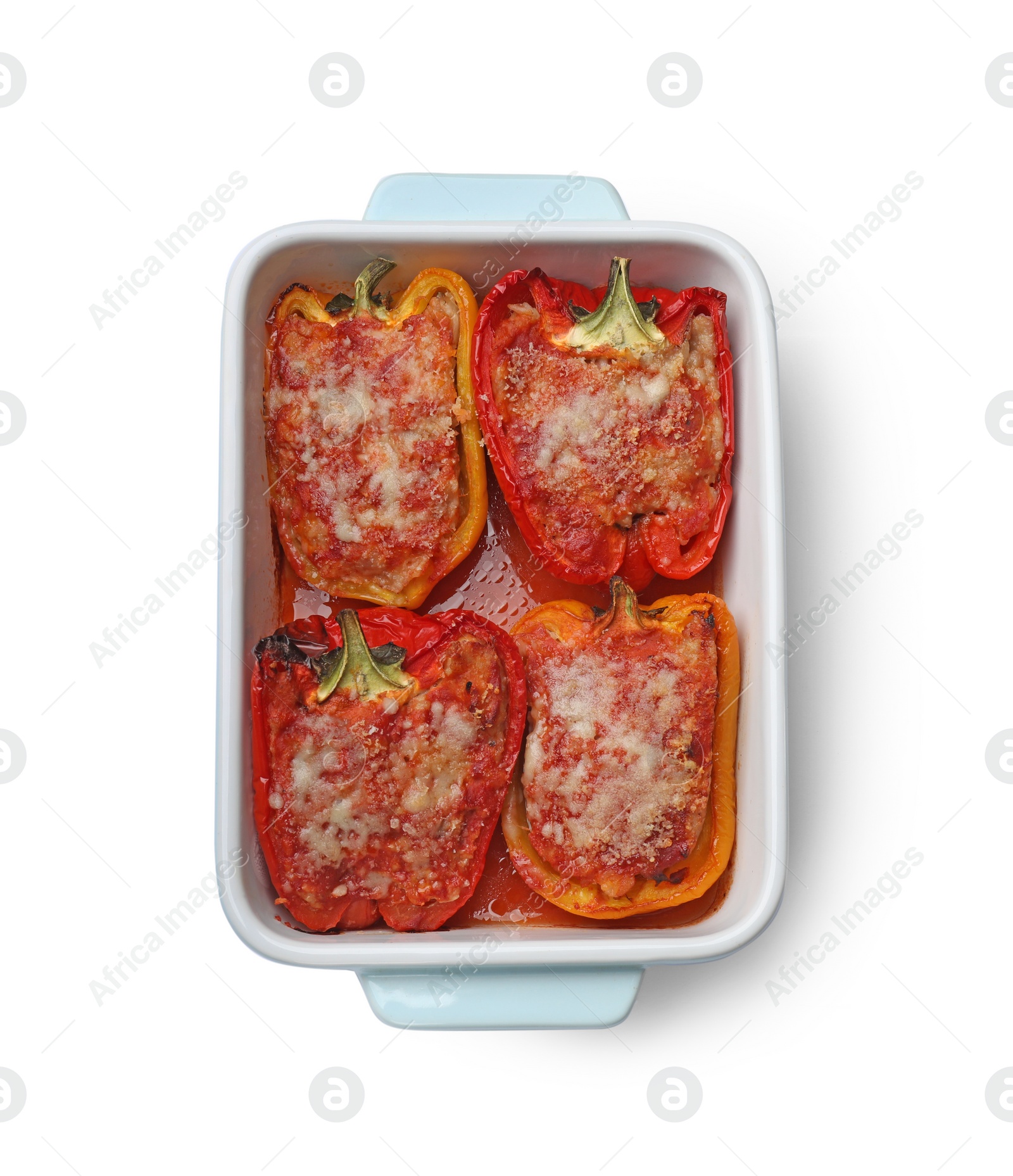 Photo of Tasty stuffed peppers in dish isolated on white, top view