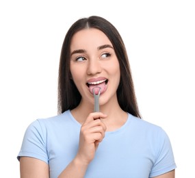 Happy woman brushing her tongue with cleaner on white background