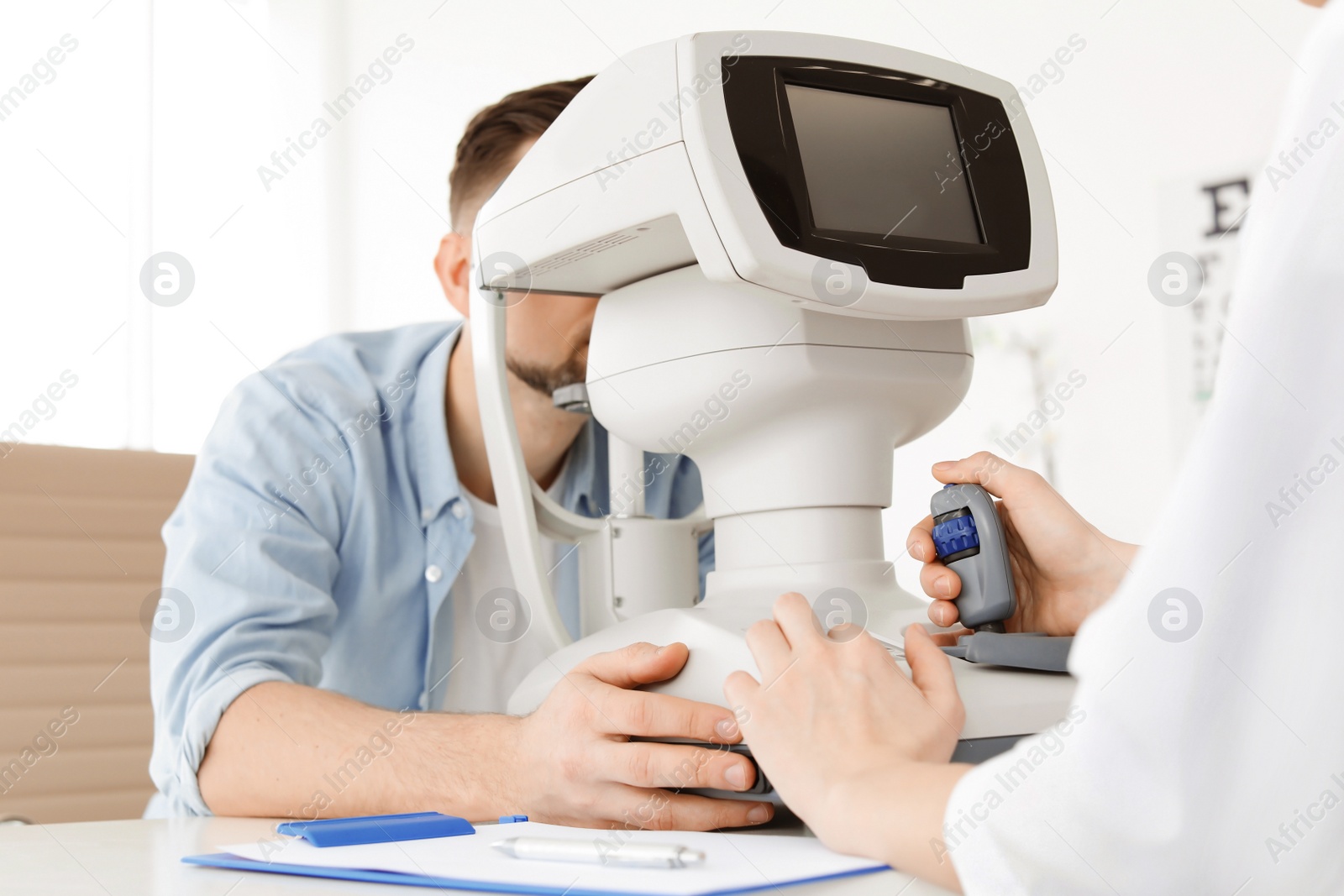 Photo of Ophthalmologist examining patient in clinic