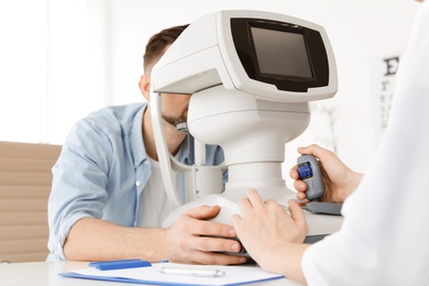 Ophthalmologist examining patient in clinic