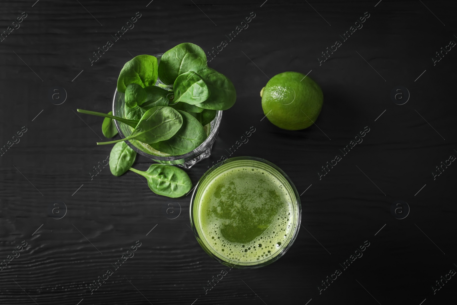 Photo of Glasses with delicious detox juice and ingredients on dark background, top view