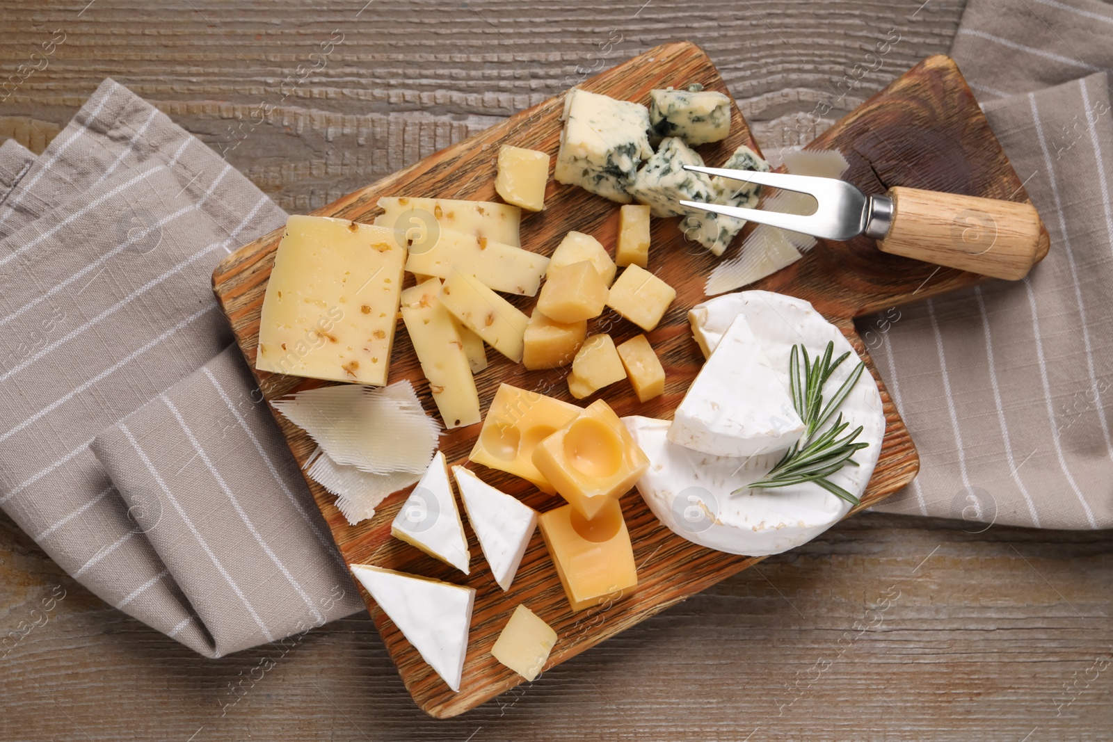 Photo of Cheese plate on wooden table, top view
