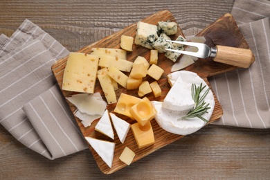 Cheese plate on wooden table, top view