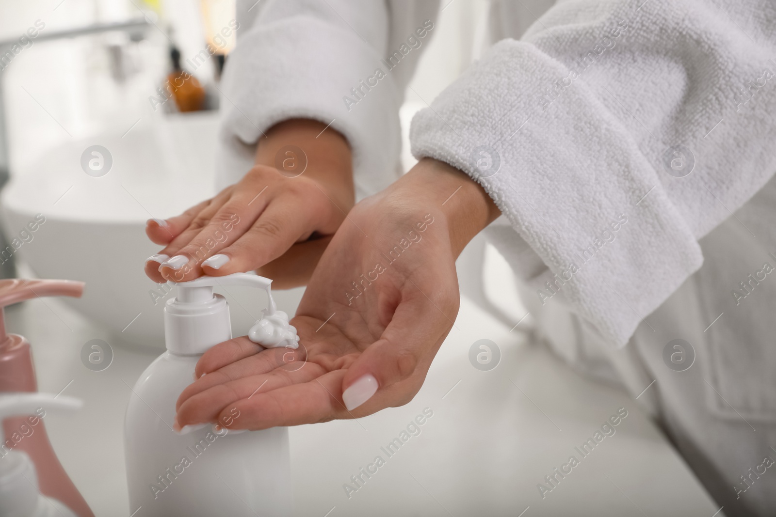 Photo of Teenage girl using gel in bathroom, closeup. Skin care cosmetic