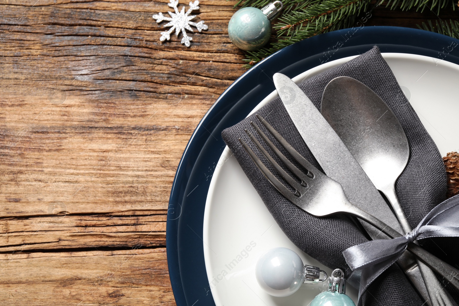 Photo of Beautiful Christmas table setting and festive decor on wooden background, flat lay. Space for text