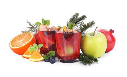 Photo of Aromatic Sangria drink in glasses, ingredients and Christmas decor on white background