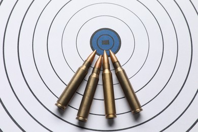 Photo of Metal bullets on shooting target, above view
